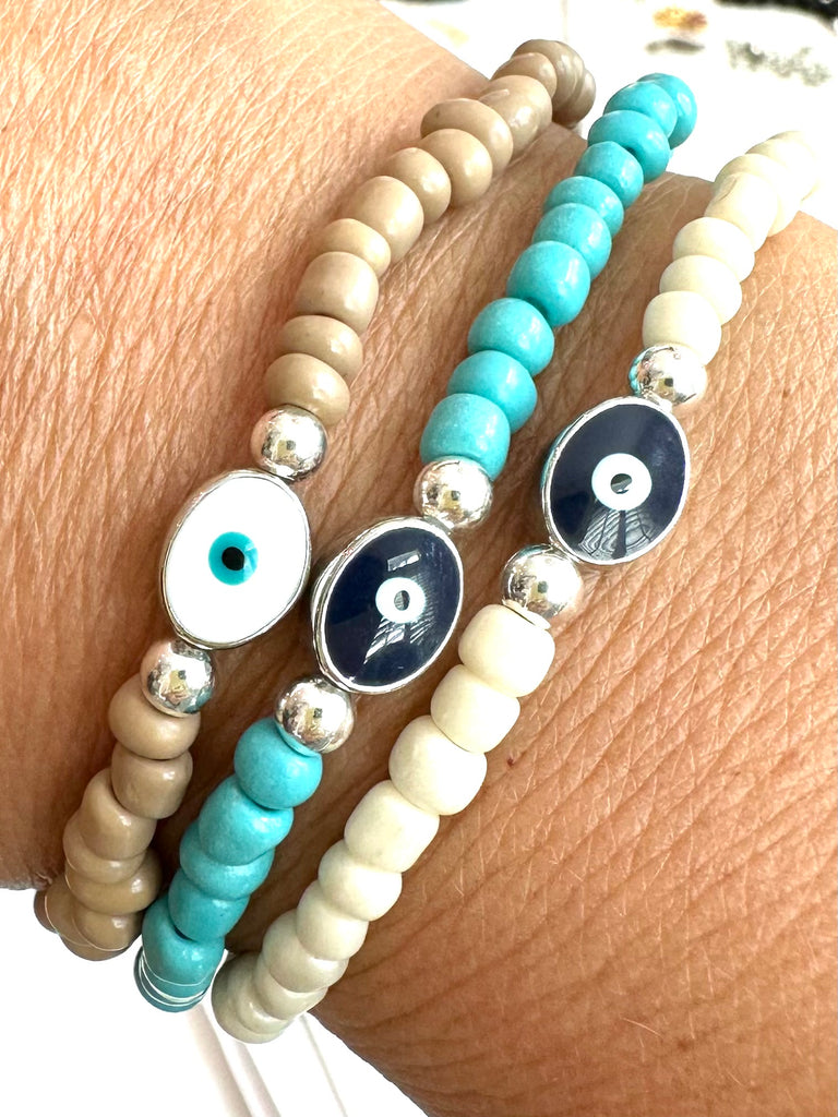 SEED BEAD BRACELET WITH ENAMEL EVIL EYE CENTER BEAD